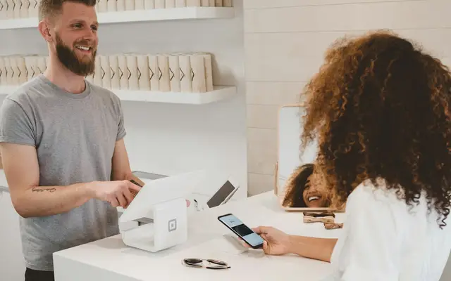 Customer paying a bill at a shop counter