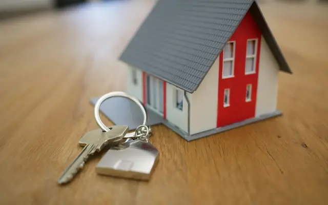 House model with keys for land and property documents